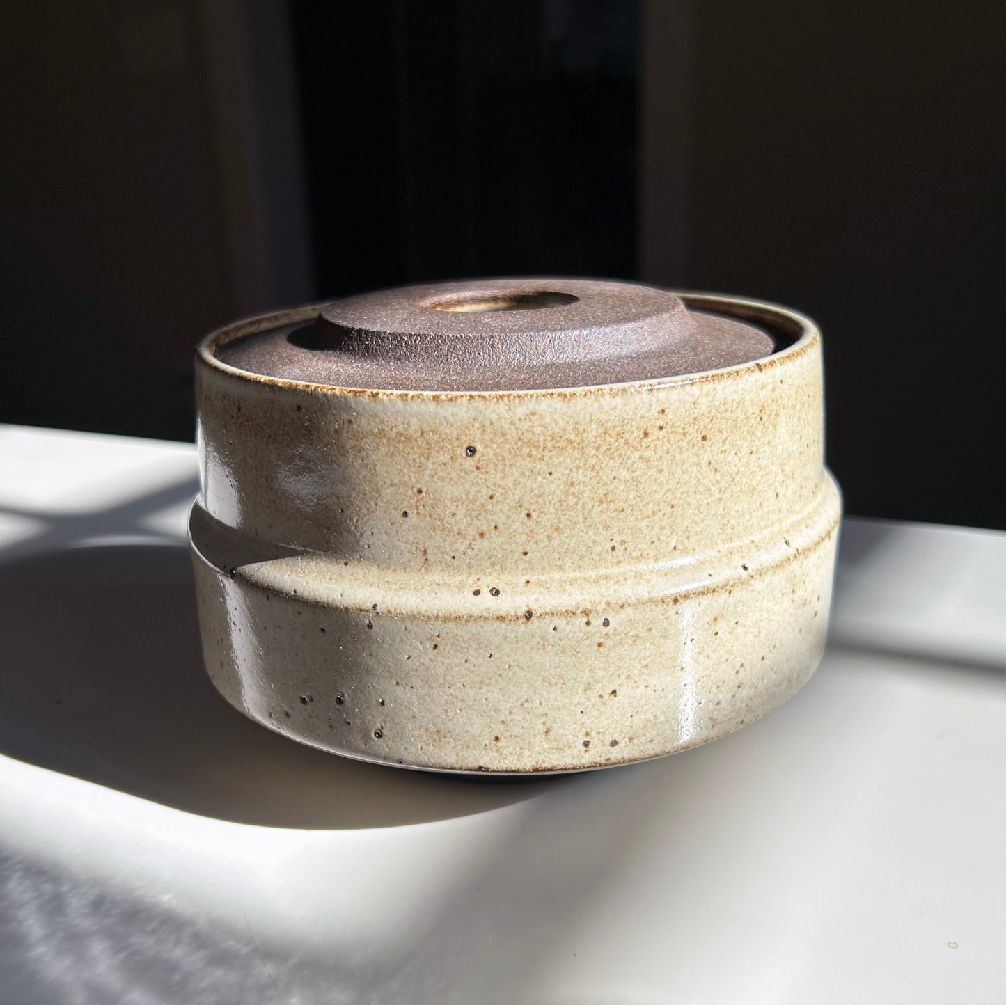 Wide, Dark Brown Lidded Vessel in Warm White